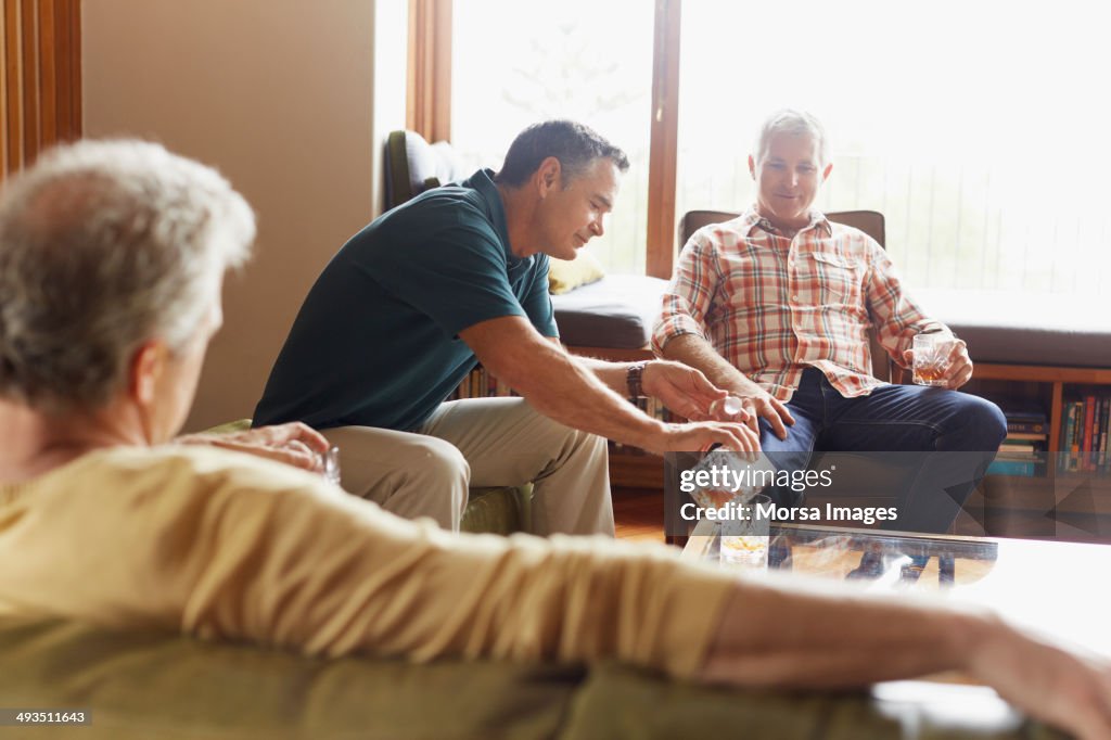 Man pouring alcohol for friends