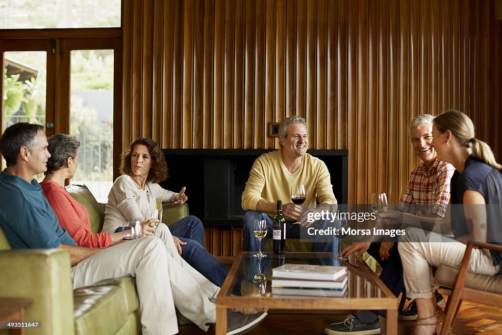 Mature friends having wine at home