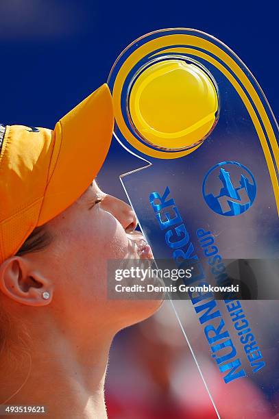 Eugenie Bouchard of Canada kisses the trophy after defeating Karolina Pliskova of Czech Republic during Day 8 of the Nuernberger Versicherungscup on...
