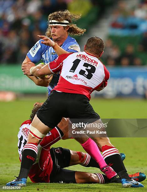 Nick Cummins of the Force attempts to break from a tackle by Coenie van Wyk and Deon van Rensburg of the Lions during the round 15 Super Rugby match...