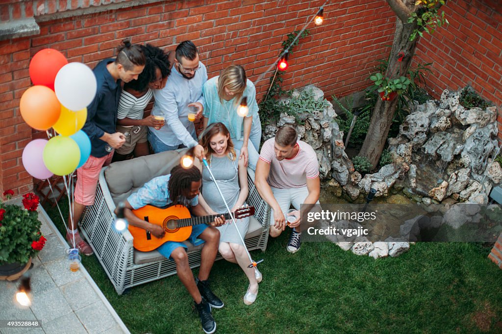 Happy Young People Making Selfie In A Backyard.