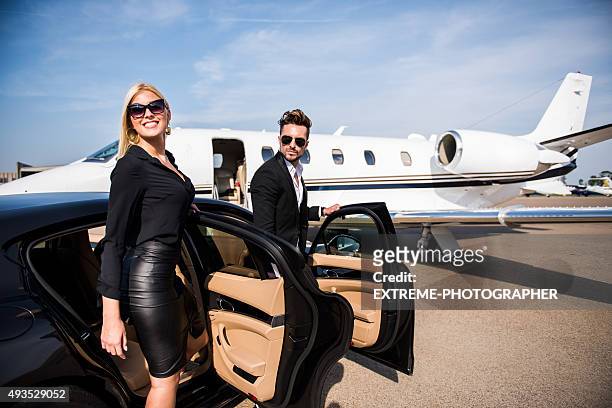 couple arriving at the airport - private jet stockfoto's en -beelden