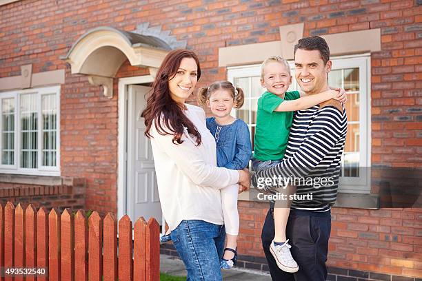 young family outside their home - council estate uk stock pictures, royalty-free photos & images