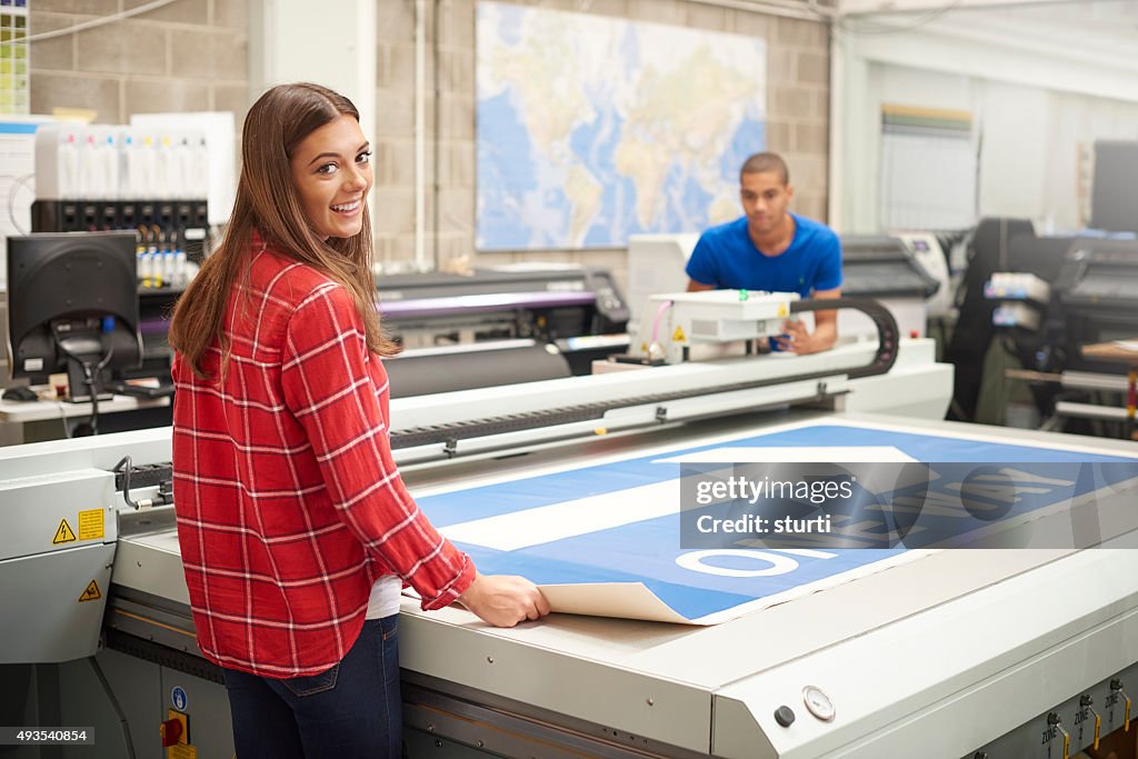Young woman working at a digital printers