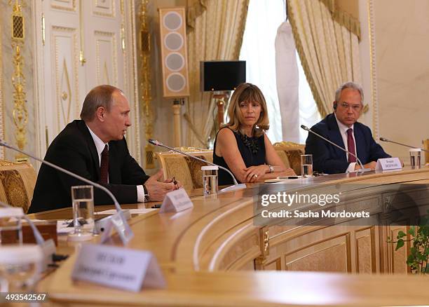 Russian President Vladimir Putin speaks at a panel with AFP's Regional Director for Europe Africa, Florence Biedermann and ANSA's Director-General...