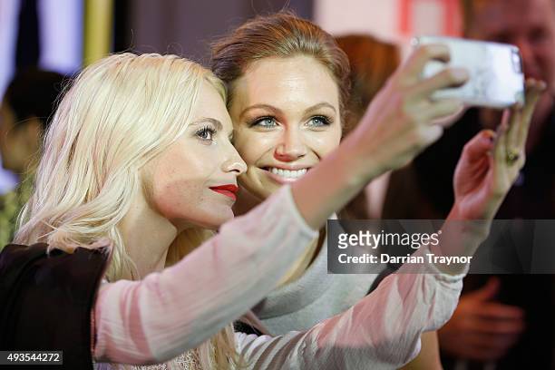 Poppy Delevingne takes a selfie with guests at the launch of the first Australian MRP store at Melbourne Central on October 21, 2015 in Melbourne,...