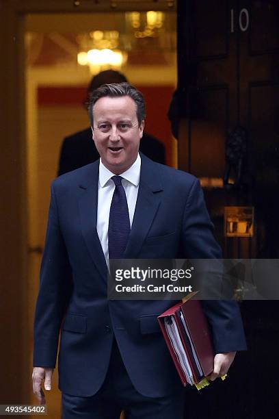 British Prime Minister David Cameron leaves for Parliament to attend Prime Minister's Questions on October 21, 2015 in Downing Street in London,...