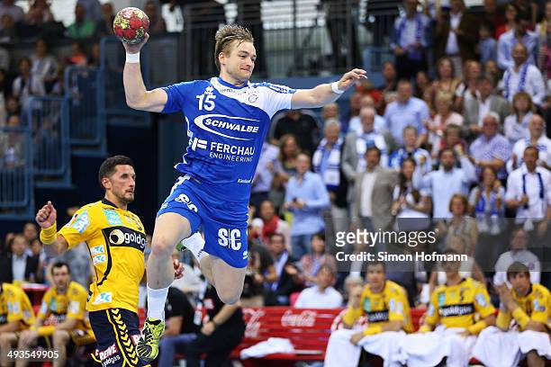 Joerg Luetzelberger of Gummersbach tries to score during the DKB Handball Bundesliga match between VfL Gummersbach and Rhein-Neckar Loewen at...