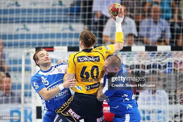 Kim Ekdahl du Rietz of Rhein-Neckar Loewen is challenged by Michal Kopco and Joerg Luetzelberger of Gummersbach during the DKB Handball Bundesliga...