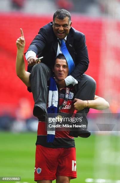 Joey Barton of Queens Park Rangers lifts Queens Park Rangers Chairman Tony Fernandes onto his shoulders following their victory during the Sky Bet...