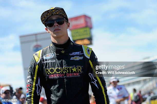 Dylan Kwasniewski, driver of the Rockstar Chevrolet, stands on the grid during qualifying for the NASCAR Nationwide Series History 300 at Charlotte...