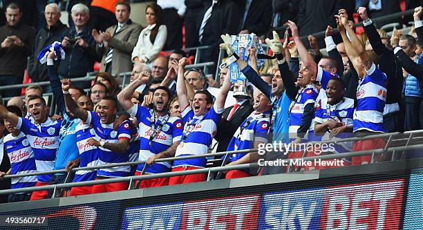 Joey Barton and Clint Hill of Queens Park Rangers lift the winners trophy following their sides victory during the Sky Bet Championship Playoff Final...