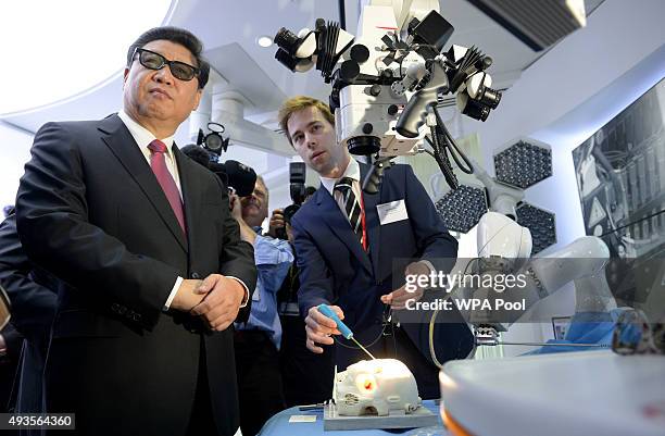 Chinese President Xi Jinping wears 3D glasses to view robotic equipment in the Hamlyn Centre for Medical Robotics during a visit to Imperial College...