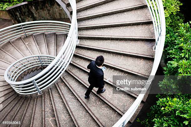 spiralling upwards - walking up stairs stockfoto's en -beelden