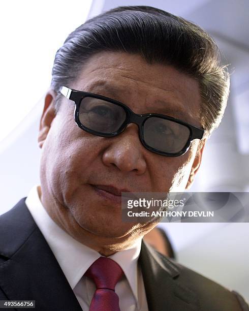 Chinese President Xi Jinping wears 3-D glasses as he is shown a demonstration of medical equiptment during a Hamlyn Centre for Robotic Surgery...