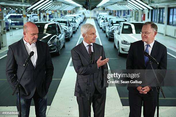 New Volkswagen Group Chairman Matthias Mueller , Volkswagen Work Council head Bernd Osterloh and Lower Saxony Governor Stephan Weil speak to the...