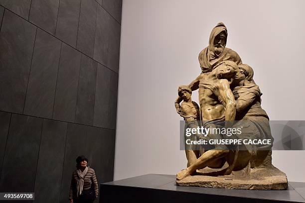 Woman looks at the "Pieta'" of Michelangelo Buonarotti during a press preview of the new "Museo dell'Opera del Duomo" in Florence on October 21,...