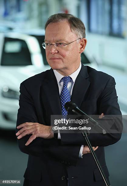 Stephan Weil speaks to the media with Volkswagen Group Chairman Matthias Mueller while standing at the assembly line of the Volkswagen factory on...