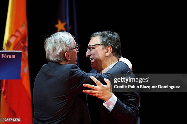 Former European Commission President Jose Manuel Barroso congratulates to current European Commission President Jean-Claude Juncker after receiving...