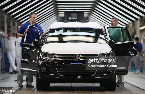 Workers conduct final inspections and prepare finished Volkswagen cars for transport at the end of the assembly line prior to a visit by Volkswagen...