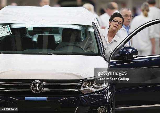 Workers conduct final inspections and prepare finished Volkswagen cars for transport at the end of the assembly line prior to a visit by Volkswagen...