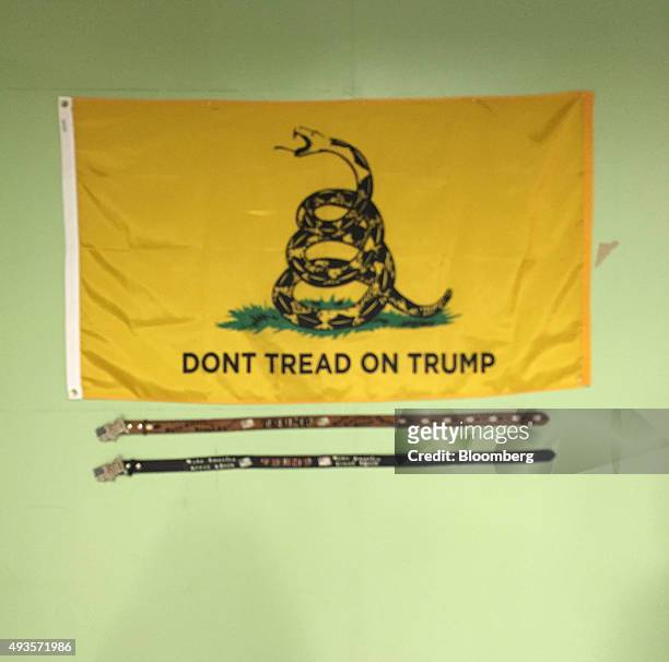 Yellow flag with the words 'Don't Tread on Trump' and two leather belts given by Trump supporters, sit on the wall inside Donald Trump's 2016...
