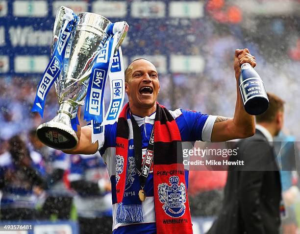 Match winning goalscorer Bobby Zamora of Queens Park Rangers celebrates with the winners trophy following his sides victory during the Sky Bet...