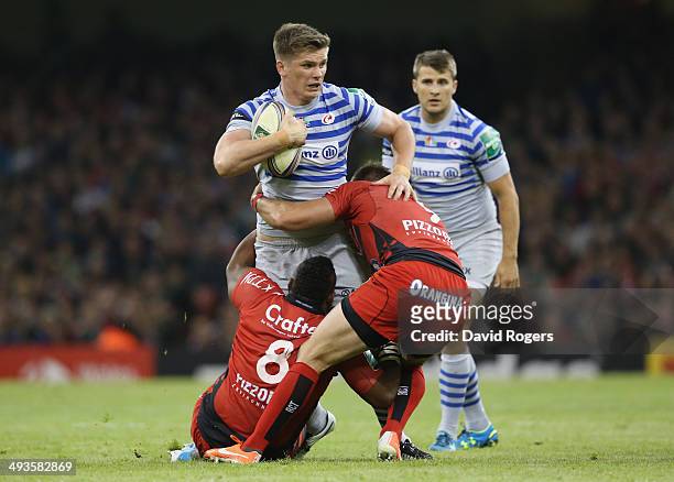 Owen Farrell of Saracens is tackled by Steffon Armitage and Sebastien Tillous-Borde during the Heineken Cup Final between Toulon and Saracens at the...