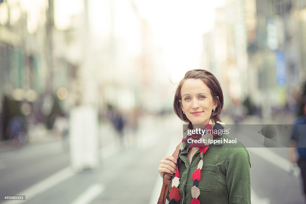 Woman smiling at camera in city, Tokyo