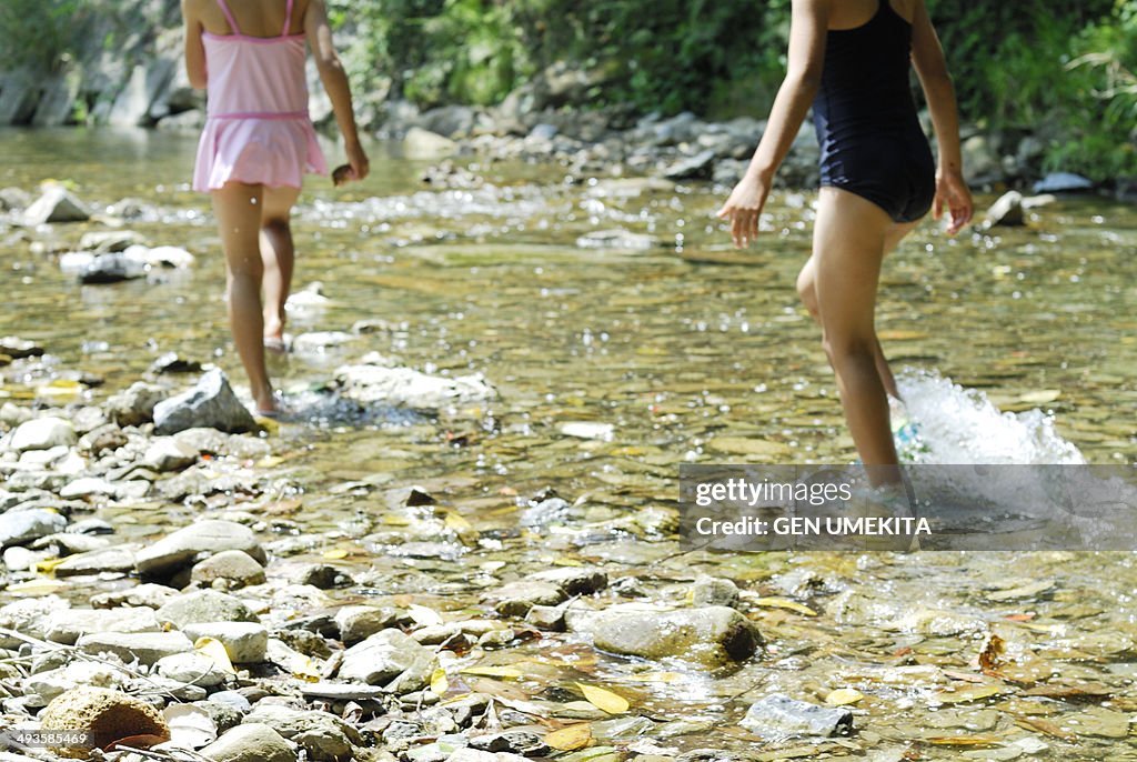 Girls playing in the river