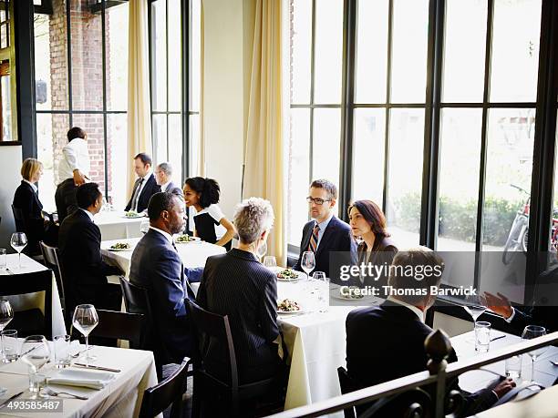 business people having lunch in restaurant - geschäftsessen stock-fotos und bilder
