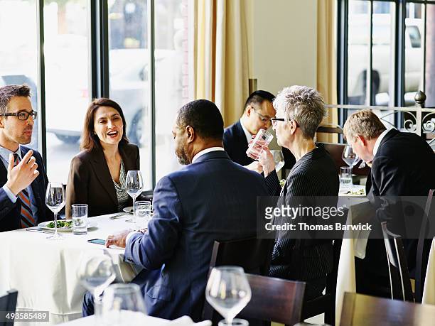 group of business executives eating in restaurant - business lunch stock-fotos und bilder