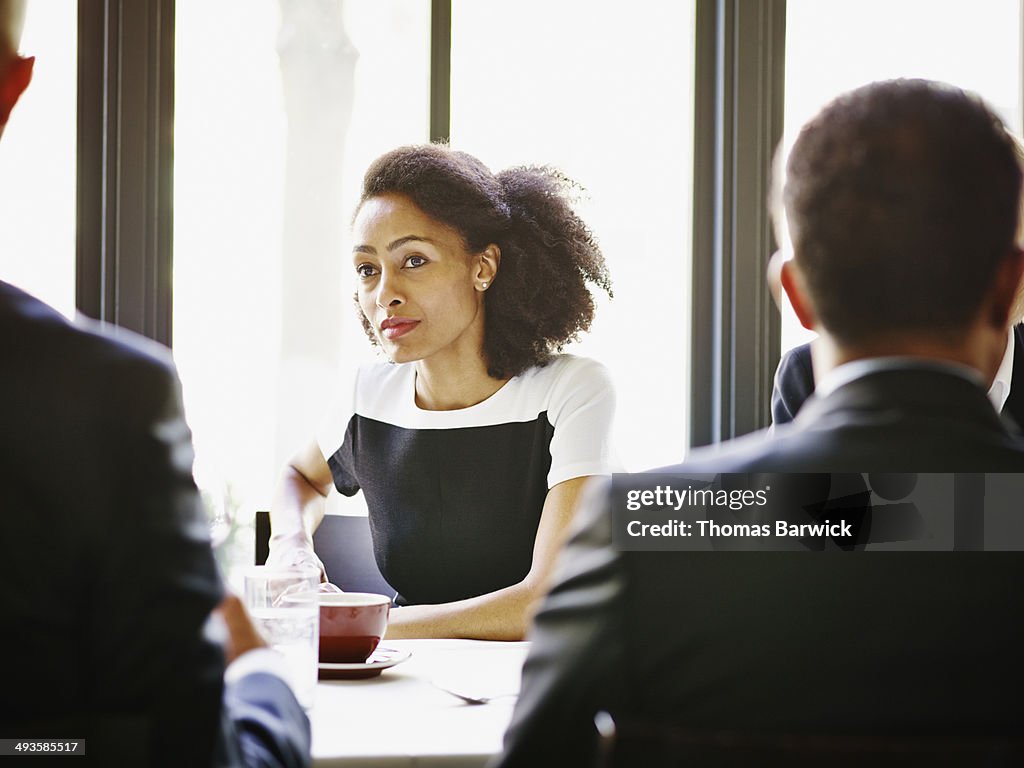 Businesswoman in lunch meeting with colleagues