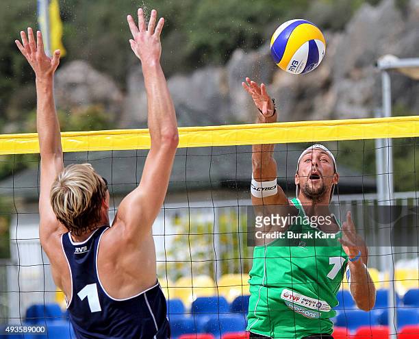 Thomas Kunert of Austria spike against Philipp Arne Bergmann of Germany during the 2nd day of the FIVB Antalya Open beach volley tournament October...