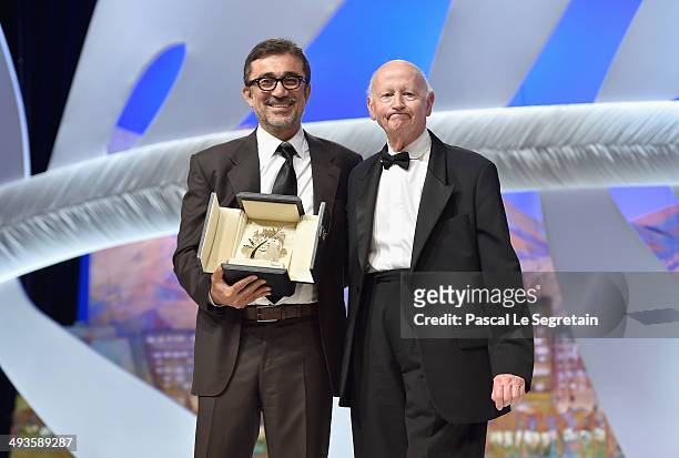 Director Nuri Bilge Ceylan poses on stage with Gilles Jacob after winning the Palme d'Or for his film "Winter's Sleeps" during the Closing Ceremony...