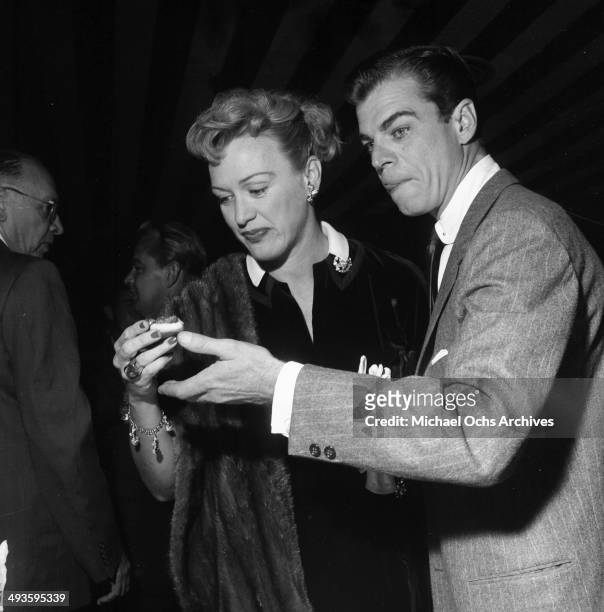 Actress Eve Arden with husband Brooks West attends a cocktail party in Los Angeles, California.