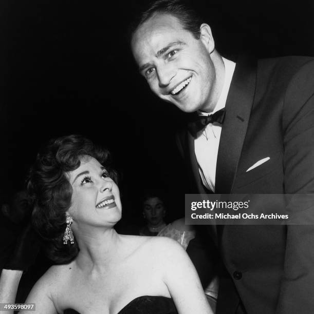 Actor Marlon Brando poses with actress Susan Hayward during the Foreign Press Awards in Los Angeles, California.