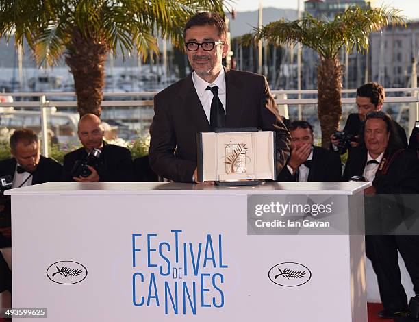 Director Nuri Bilge Ceylan poses with the Palme d'Or for his film "Winter's Sleeps" as he attends the Palme D'Or Winners photocall during the 67th...