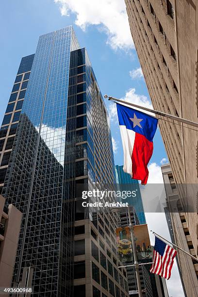 houston downtown with texas and american flags - texas flag stock pictures, royalty-free photos & images