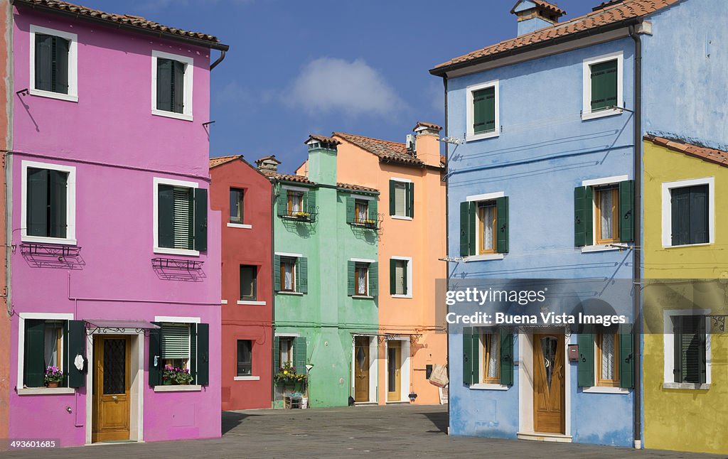 Pastel color houses over channel in Burano