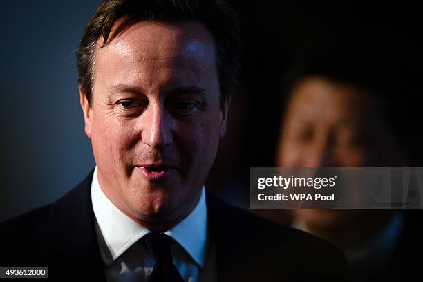 British Prime Minister David Cameron walks in front of Chinese President Xi Jinping at the UK-China Business Summit in Mansion House on October 21,...