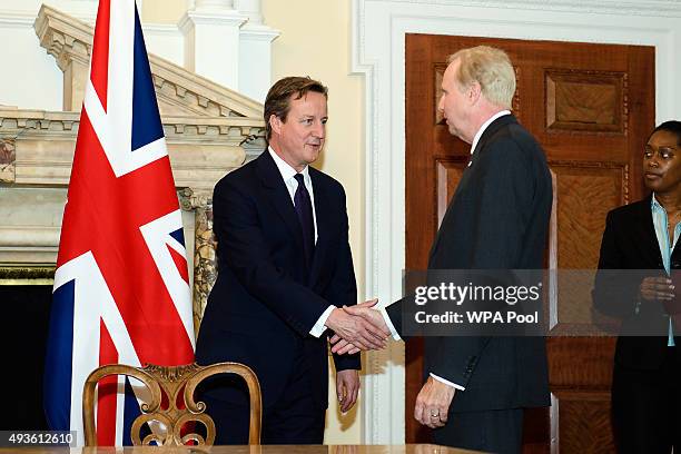 British Prime Minister David Cameron shakes hands with the Chief Executive of oil and gas company BP Bob Dudley during a commercial contract exchange...