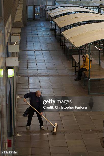 Man sweeps up at the end of market day in the centre of Rotherham on October 21, 2015 in Rotherham, England. Up to 720 staff are facing redundancy at...