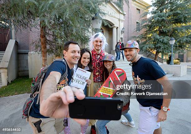 Mike Knell , dressed as the character Dr. Emmett Brown, Stephanie Knell and Jackie Peters pose with fellow fans on steps of Hill Valley Courthouse...