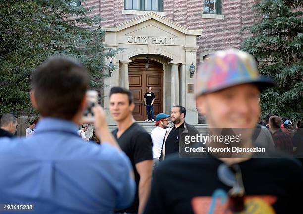 Fans pose on the city hall steps of Hill Valley Courthouse in the back lot of Universal Studios during "Back To The Future" day October 21, 2015 in...