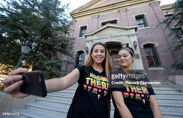 La Zvirbulis and Mirai Booth-Ong pose on steps of Hill Valley Courthouse Square in the back lot of Universal Studios during "Back To The Future" day...