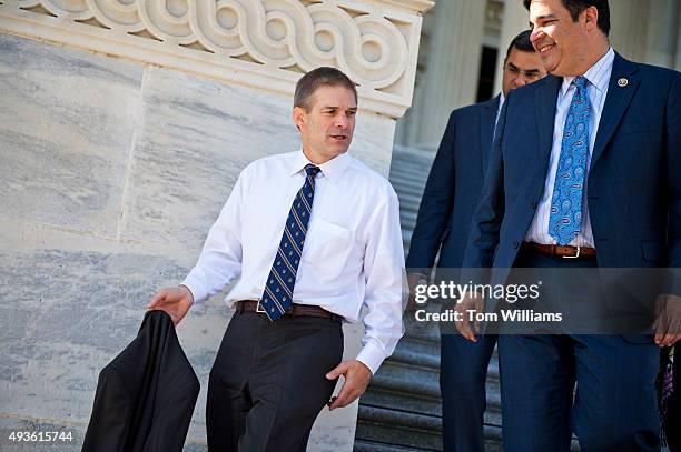 From left, Reps. Jim Jordan, R-Ohio, Justin Amash, R-Mich., and Raul Labrador, R-Idaho, descend the House steps after a vote in the Capitol, October...