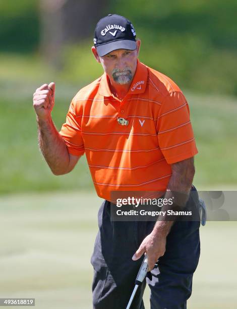 Marco Dawson reacts to a birdie putt on the 18th green during the third round of the 2014 Senior PGA Championship presented by KitchenAid at Harbor...