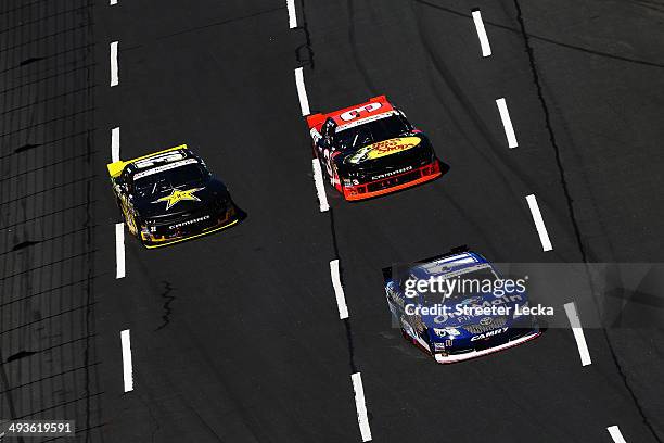 Elliott Sadler, driver of the OneMain Financial Toyota, leads Ty Dillon, driver of the Bass Pro/NWTF Chevrolet, and Dylan Kwasniewski, driver of the...