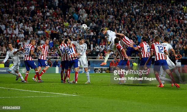 Sergio Ramos of Real Madrid heads in their first goal during the UEFA Champions League Final between Real Madrid and Atletico de Madrid at Estadio da...